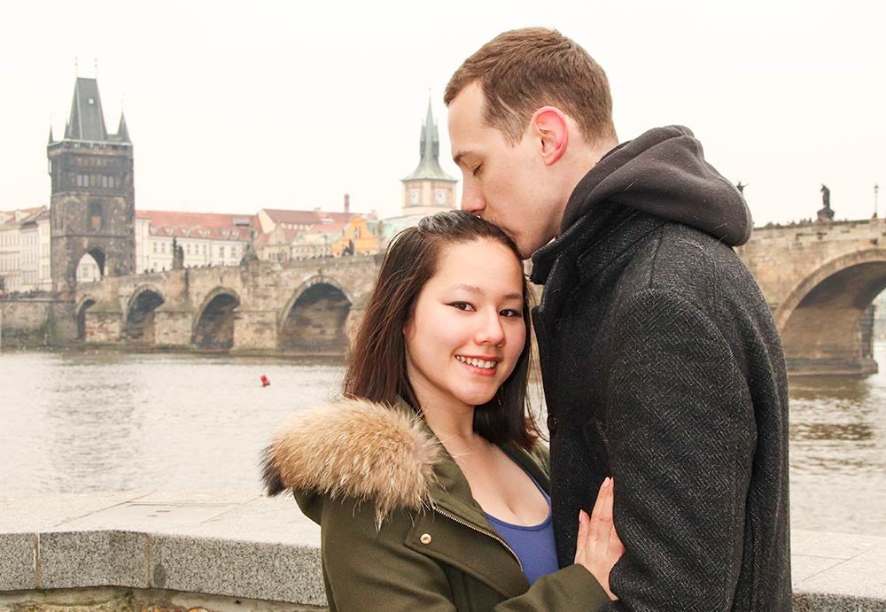 Young couple in love at charles bridge prague